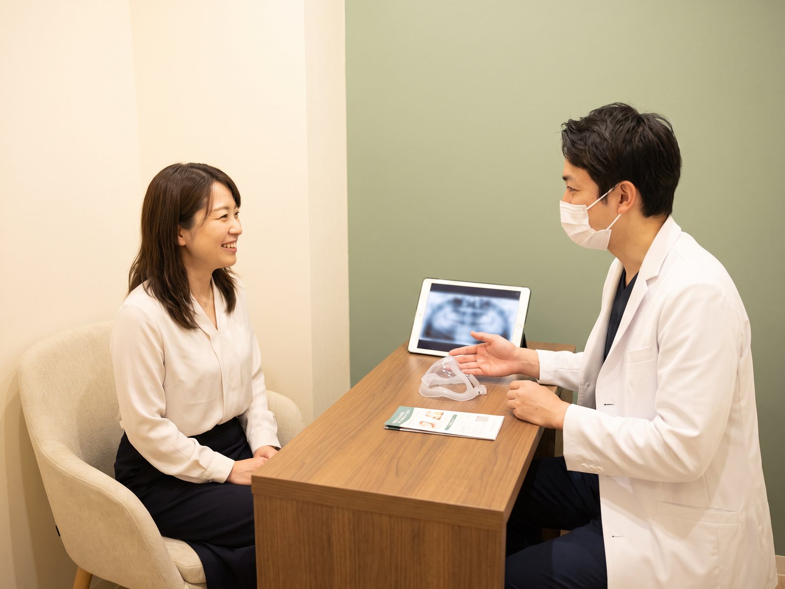 Dentist discussing inhaled sedation and medical history with an adult patient